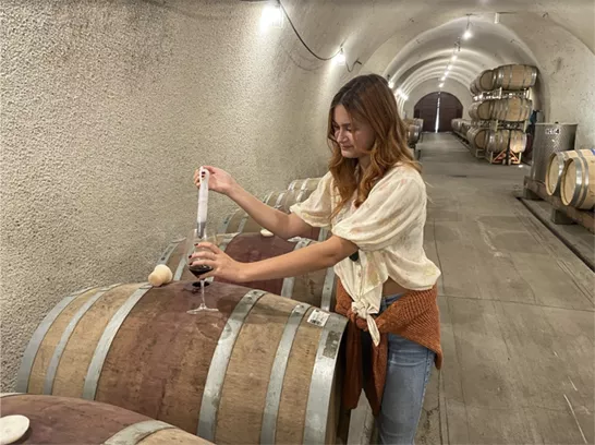 young girl doing winemaker tasks